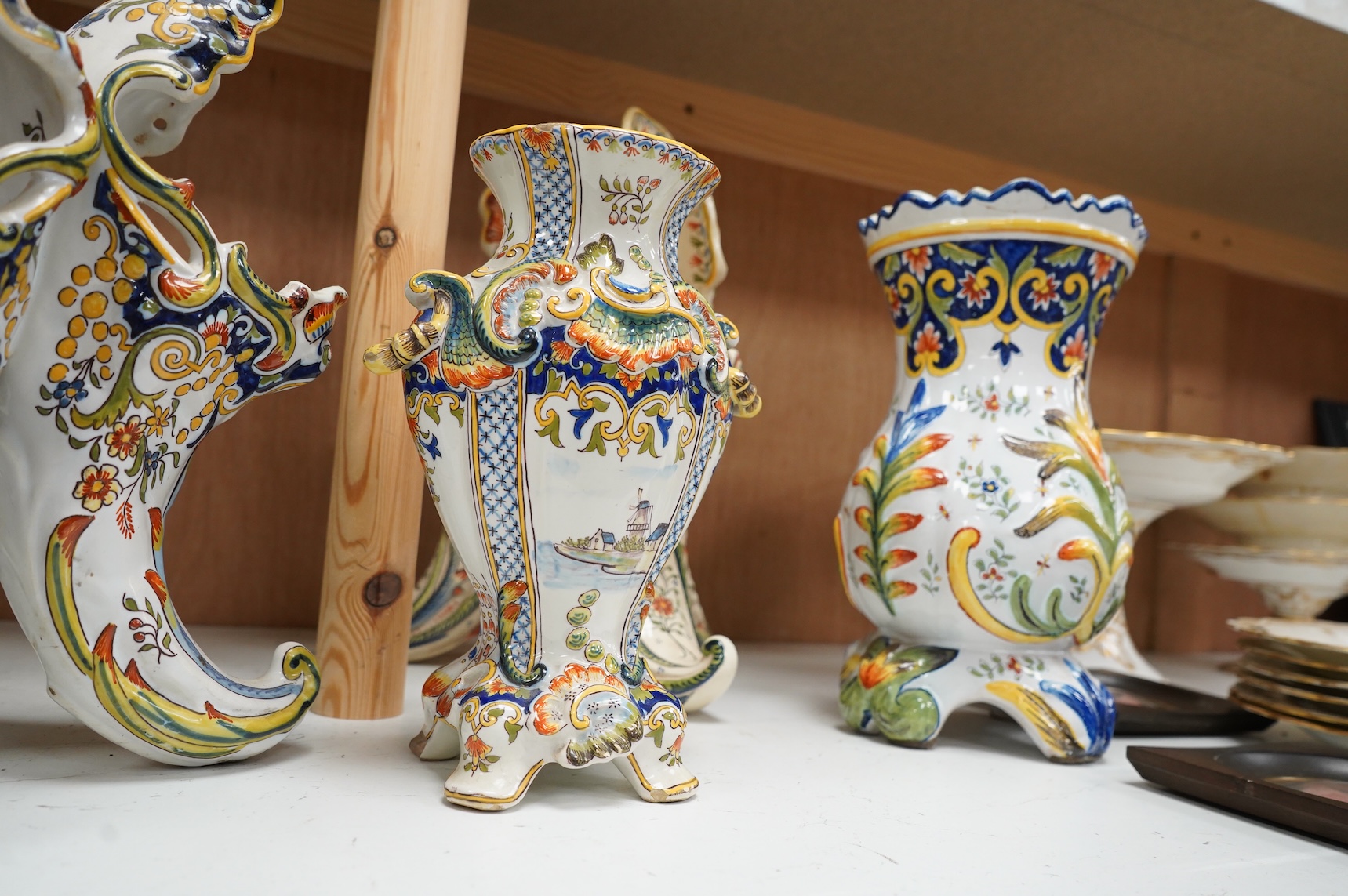Two late 19th / early 29th century French faience vases and two similar centrepieces, largest 35cm high